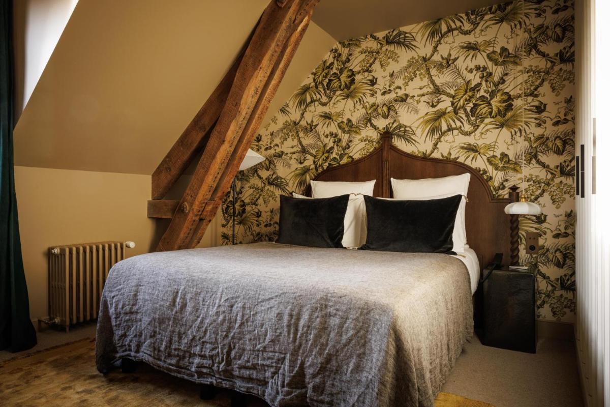 Un ou plusieurs lits dans un hébergement de l'établissement Domaine de Locguénolé & Spa - Relais & Chateaux