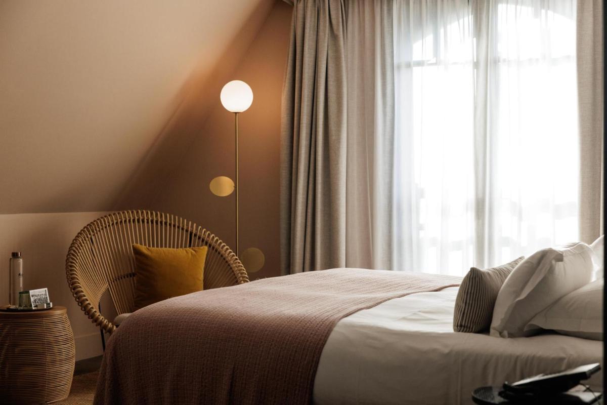 Un ou plusieurs lits dans un hébergement de l'établissement Le Celtique & Spa