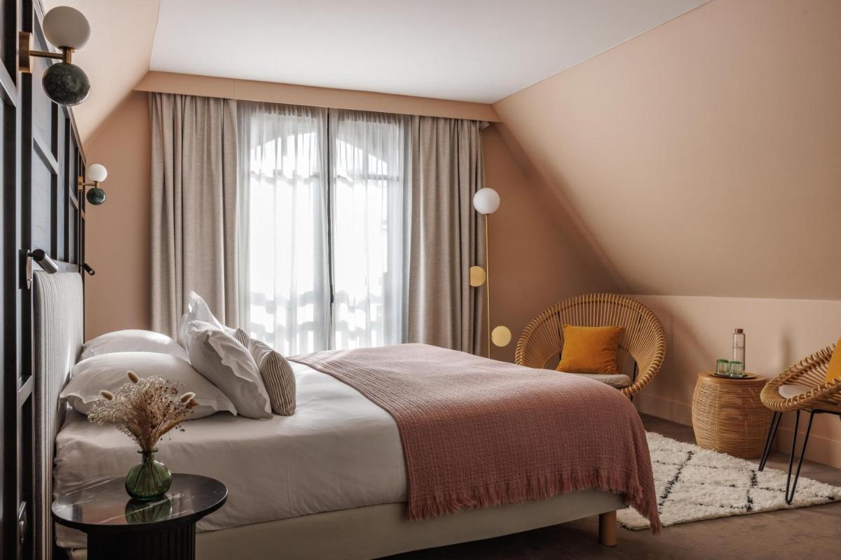 Un ou plusieurs lits dans un hébergement de l'établissement Le Celtique & Spa