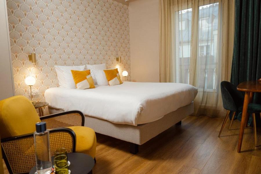 Un ou plusieurs lits dans un hébergement de l'établissement Hôtel Artemisia Montmartre