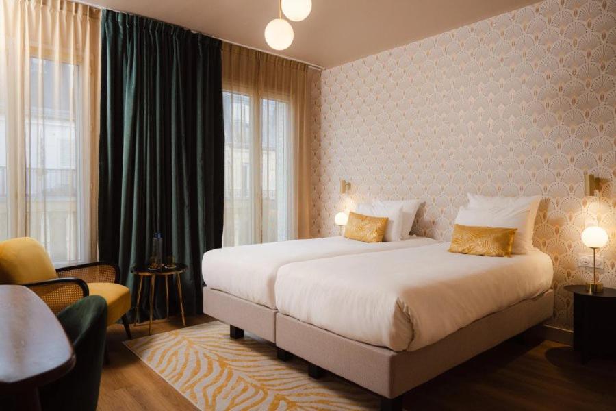 Un ou plusieurs lits dans un hébergement de l'établissement Hôtel Artemisia Montmartre