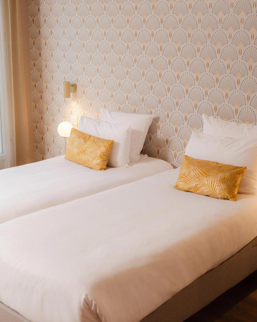Un ou plusieurs lits dans un hébergement de l'établissement Hôtel Artemisia Montmartre