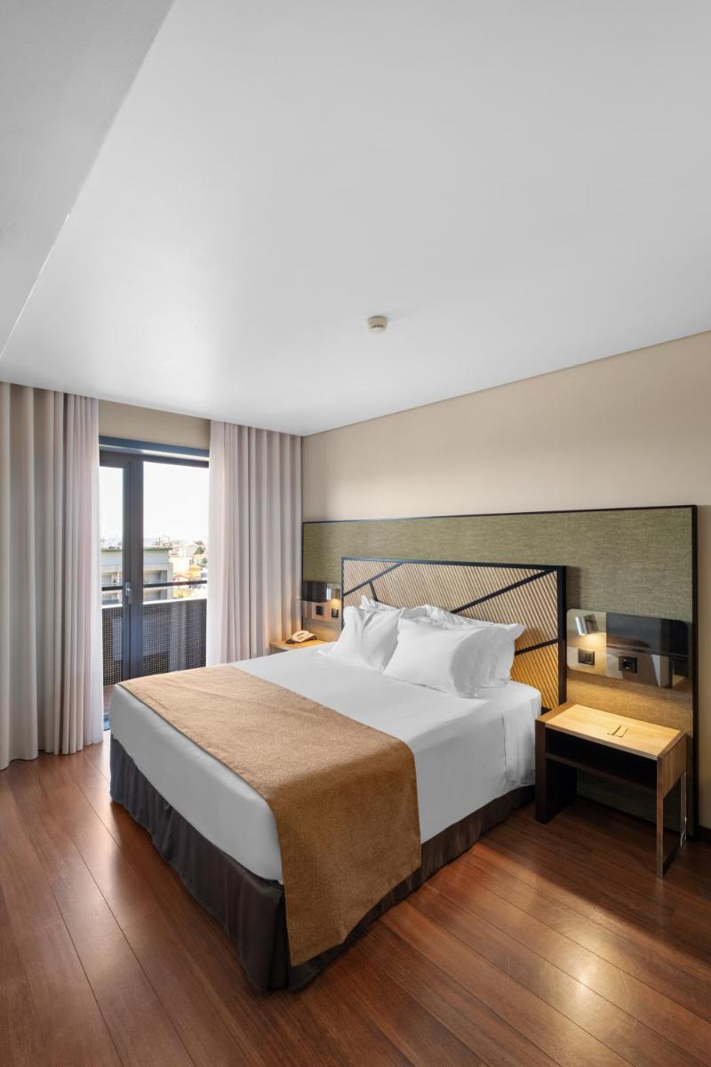 Uma cama ou camas num quarto em Axis Porto Business & Spa Hotel