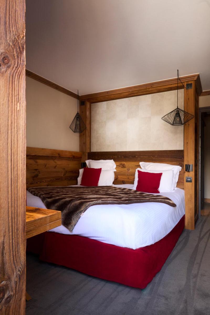 Un ou plusieurs lits dans un hébergement de l'établissement Hôtel Village Montana by Les Etincelles