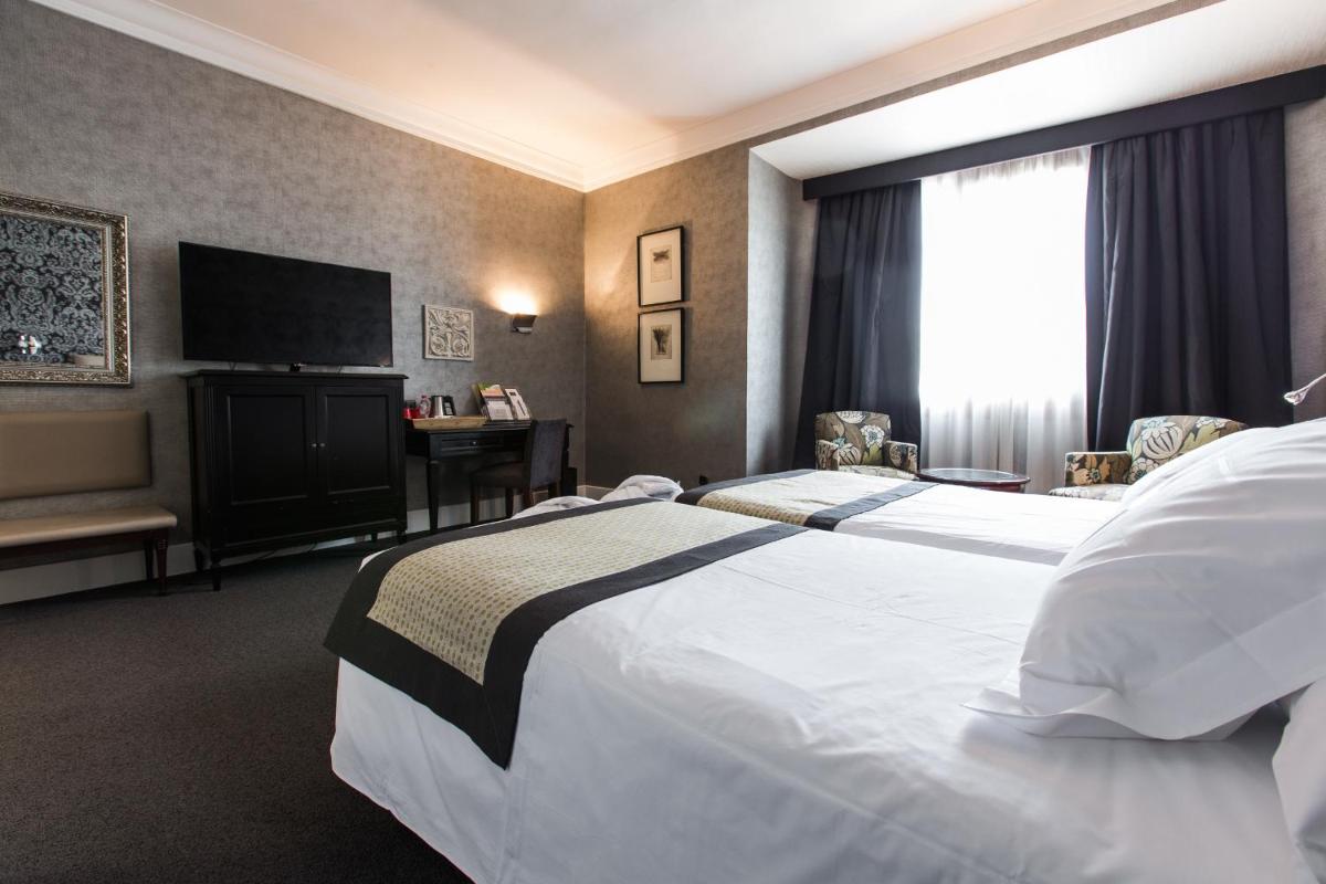 Cama o camas de una habitación en Hotel Carlton