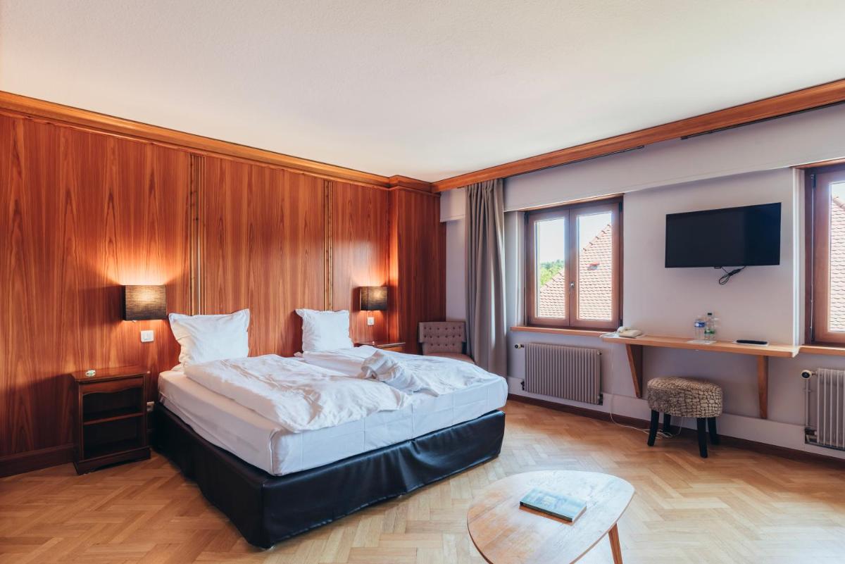 Un ou plusieurs lits dans un hébergement de l'établissement Hotel Spa et Restaurant Au Chasseur