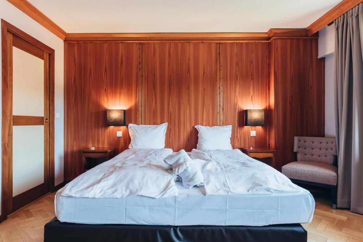 Un ou plusieurs lits dans un hébergement de l'établissement Hotel Spa et Restaurant Au Chasseur