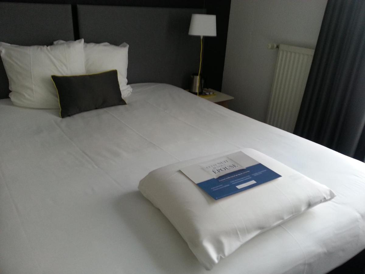 Un ou plusieurs lits dans un hébergement de l'établissement Kyriad Hotel Brest
