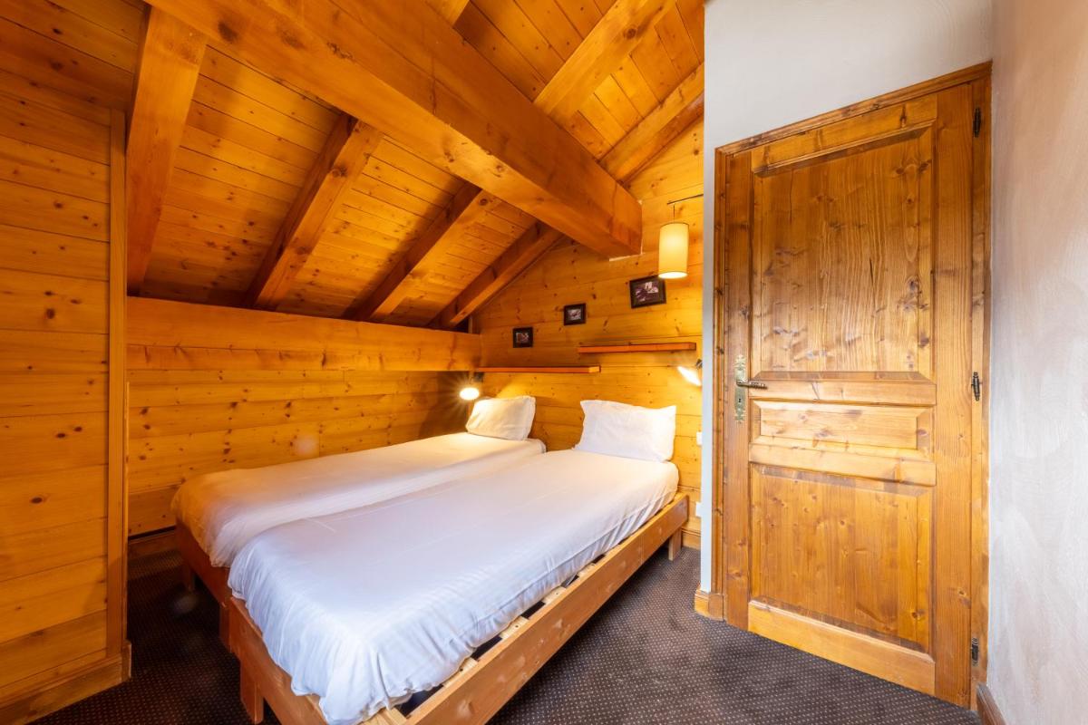 Un ou plusieurs lits dans un hébergement de l'établissement Résidences Village Montana by Les Etincelles