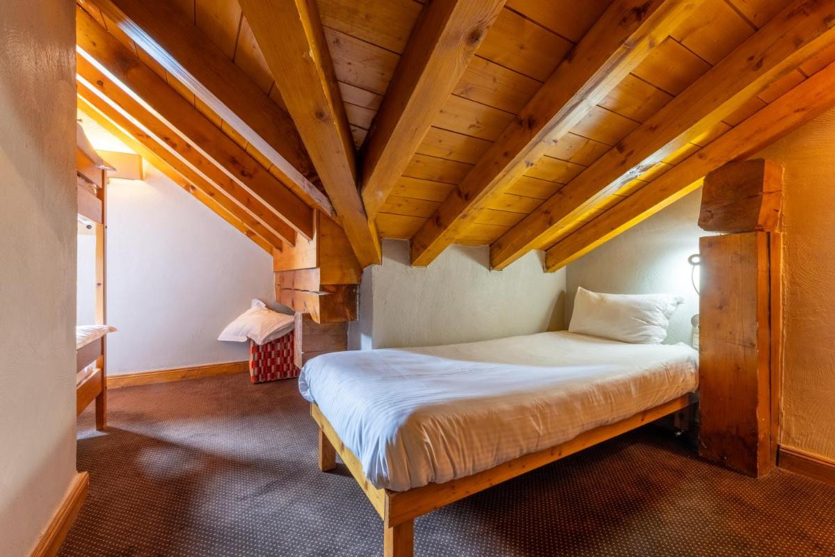 Un ou plusieurs lits dans un hébergement de l'établissement Résidences Village Montana by Les Etincelles