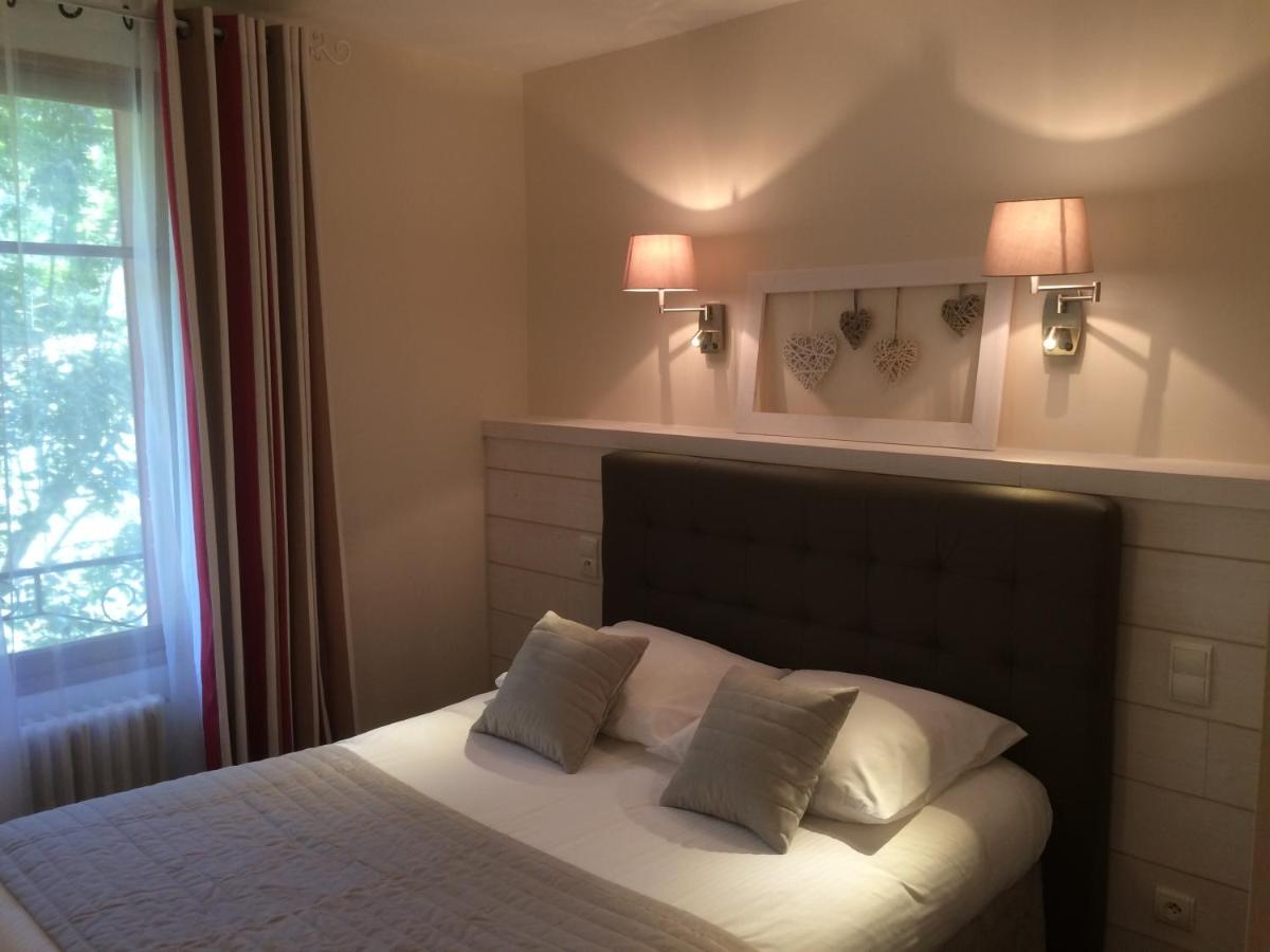 Un ou plusieurs lits dans un hébergement de l'établissement Hôtel Spa & Restaurant Ô Pervenches