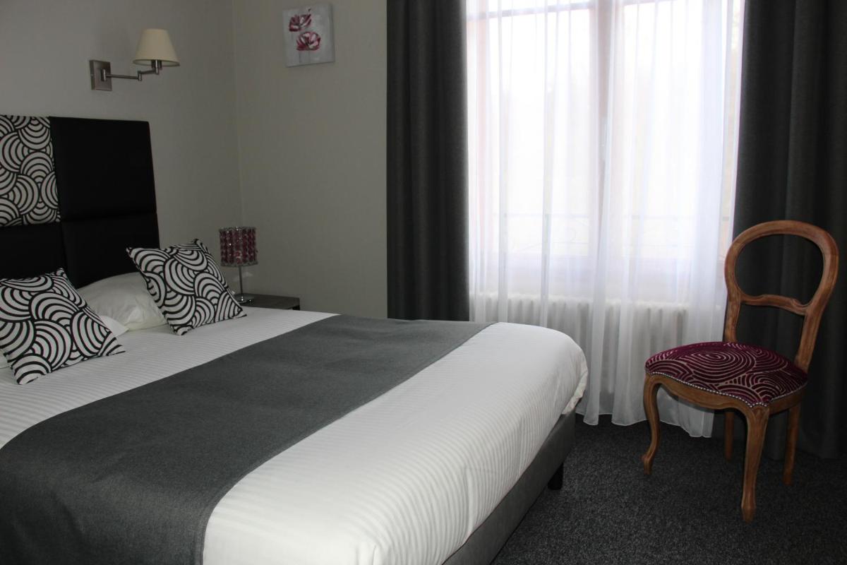 Un ou plusieurs lits dans un hébergement de l'établissement Hôtel Spa & Restaurant Ô Pervenches