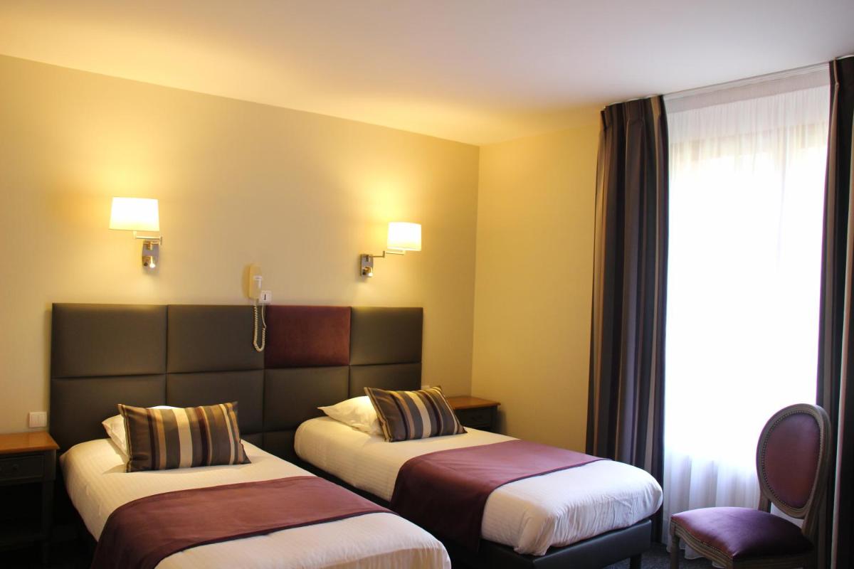 Un ou plusieurs lits dans un hébergement de l'établissement Hôtel Spa & Restaurant Ô Pervenches
