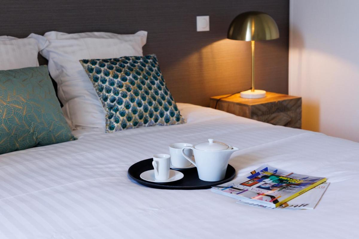 Un ou plusieurs lits dans un hébergement de l'établissement Les Boréales - Appart'hotel & Restaurant