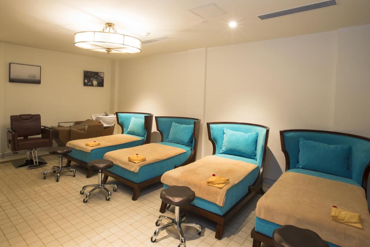 a hospital room with two beds and a table at Fragrant Nature Kochi - A Five star Classified Hotel in Cochin