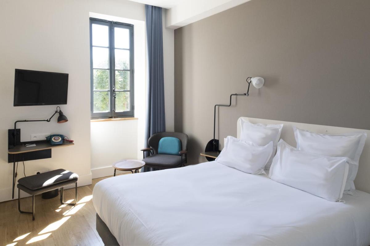 Un ou plusieurs lits dans un hébergement de l'établissement Fourvière Hôtel