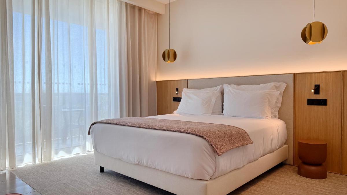 Uma cama ou camas num quarto em AP Lago Montargil - Conference & SPA