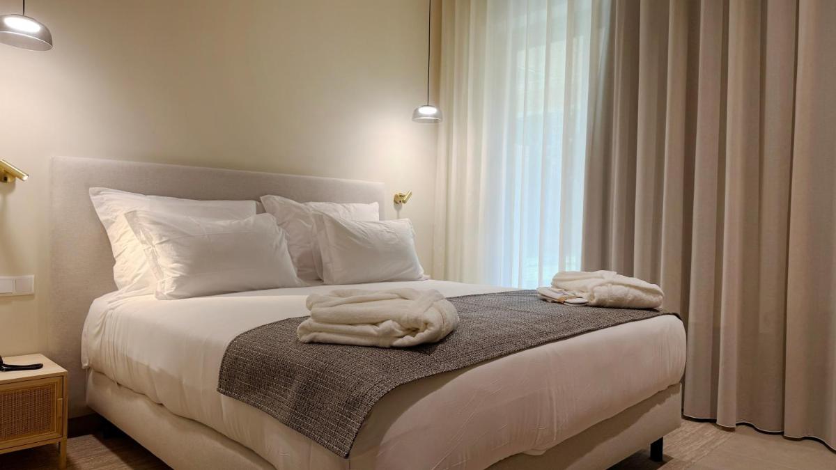 Uma cama ou camas num quarto em AP Lago Montargil - Conference & SPA