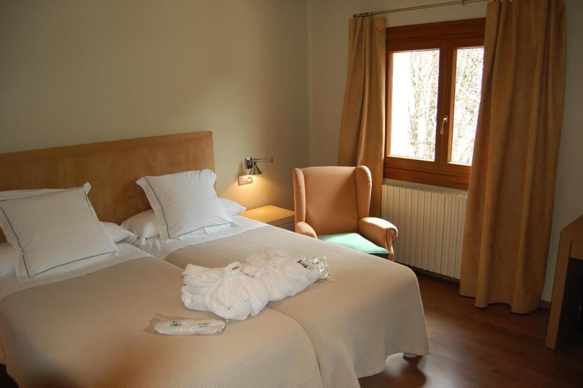 Cama o camas de una habitación en Hotel Manantial