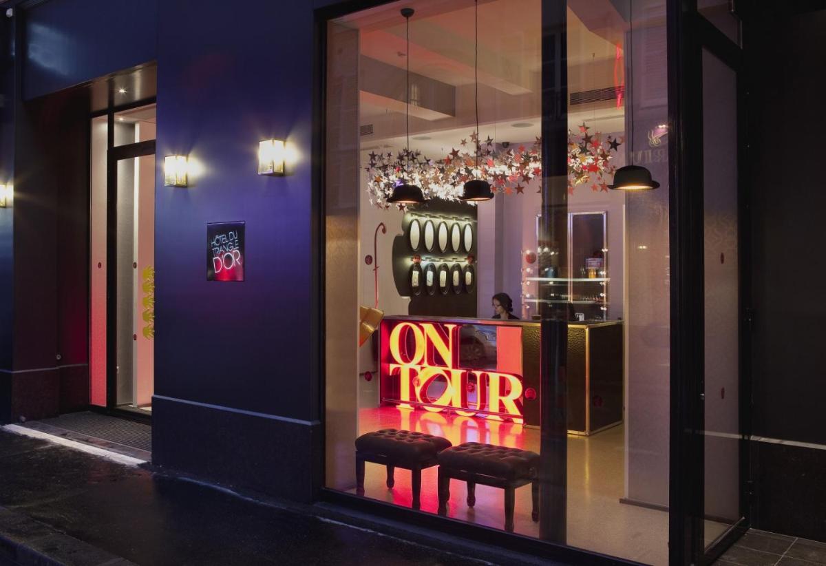 une vitrine avec une pancarte indiquant « en tournée » dans l'établissement Hôtel du Triangle d'Or, à Paris