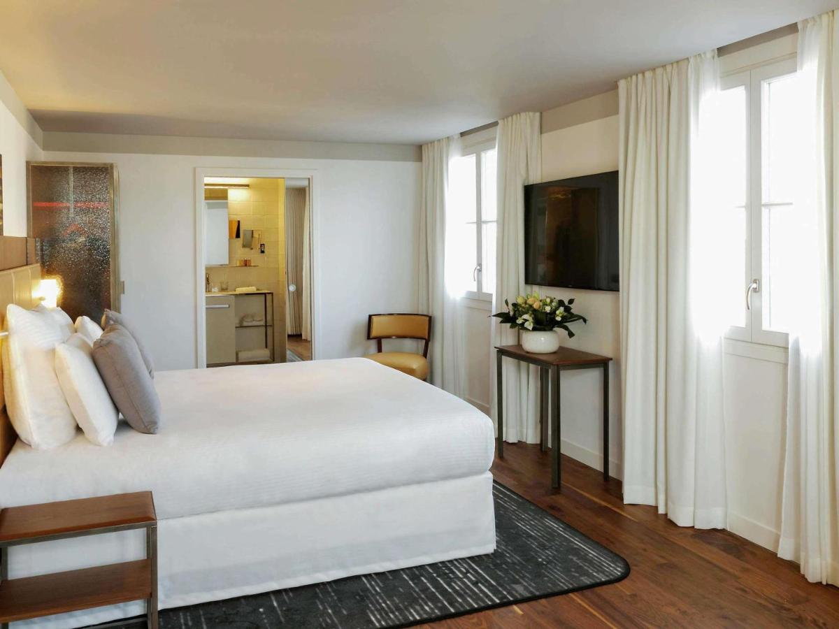 Un ou plusieurs lits dans un hébergement de l'établissement Boutet Bastille Hotel Paris - MGallery Collection