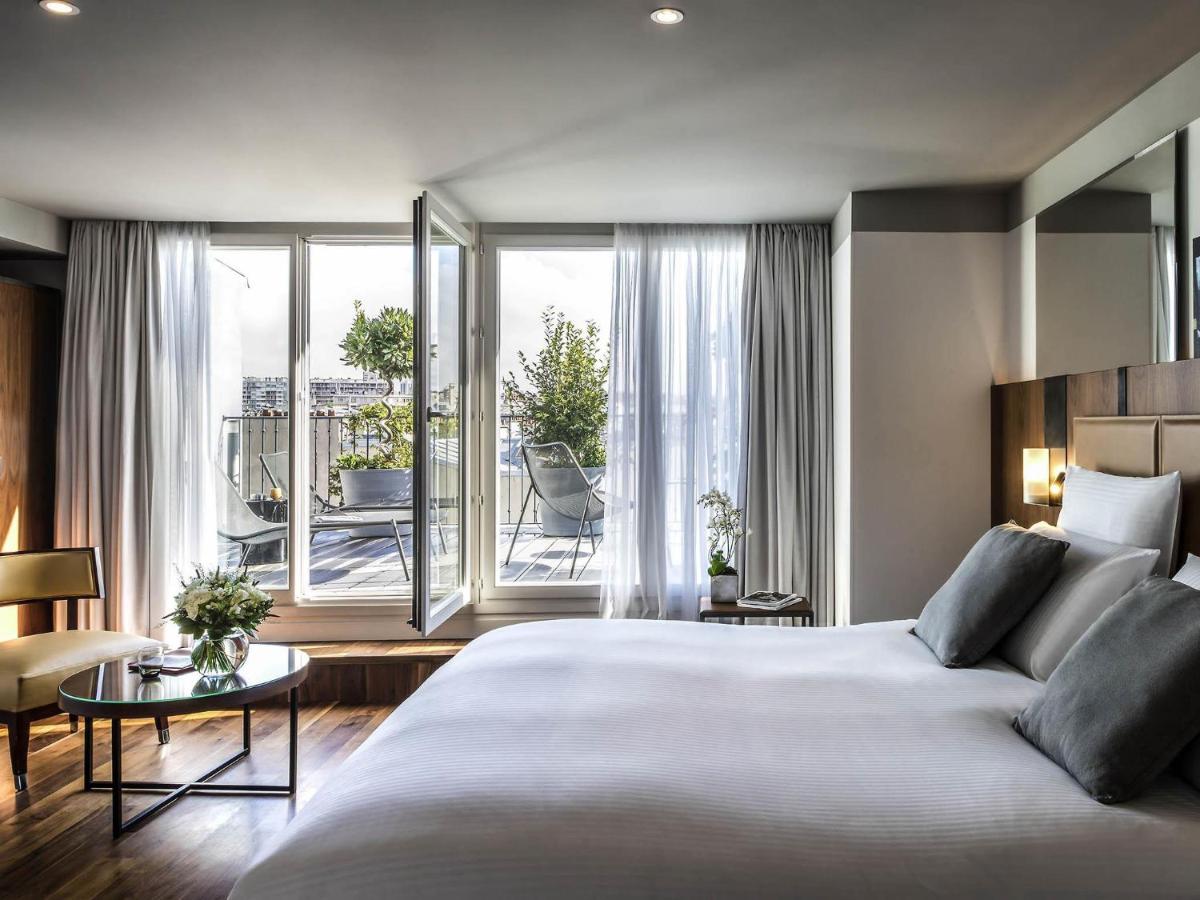 Un ou plusieurs lits dans un hébergement de l'établissement Boutet Bastille Hotel Paris - MGallery Collection