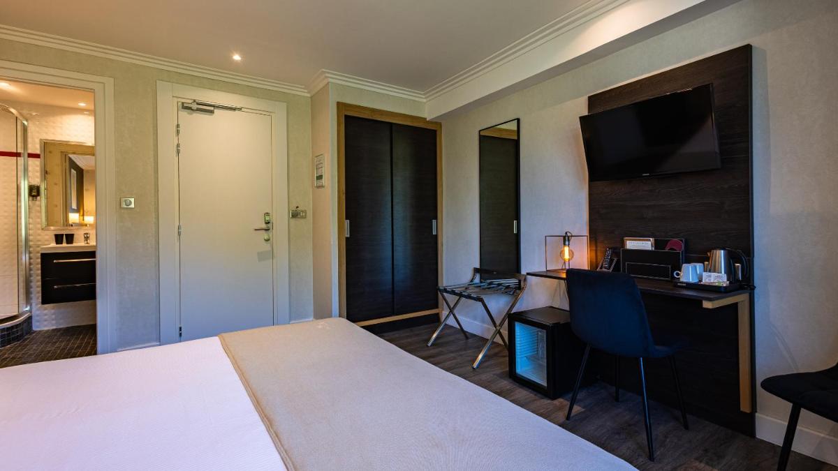 Un ou plusieurs lits dans un hébergement de l'établissement Hôtel Beau Rivage