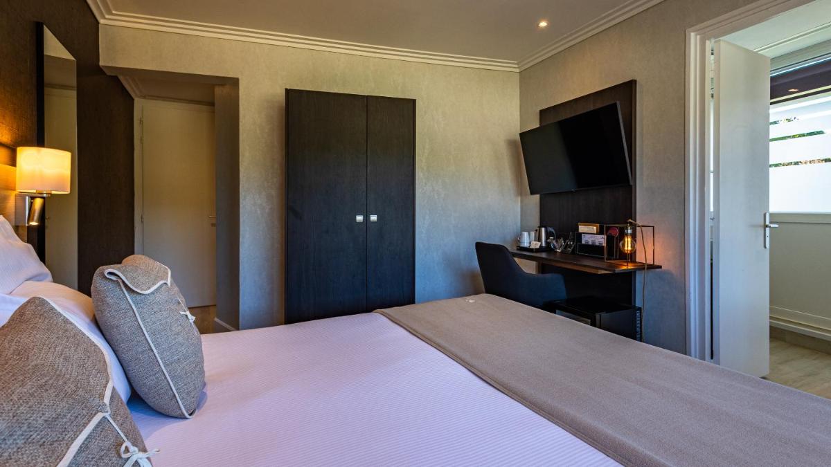Un ou plusieurs lits dans un hébergement de l'établissement Hôtel Beau Rivage