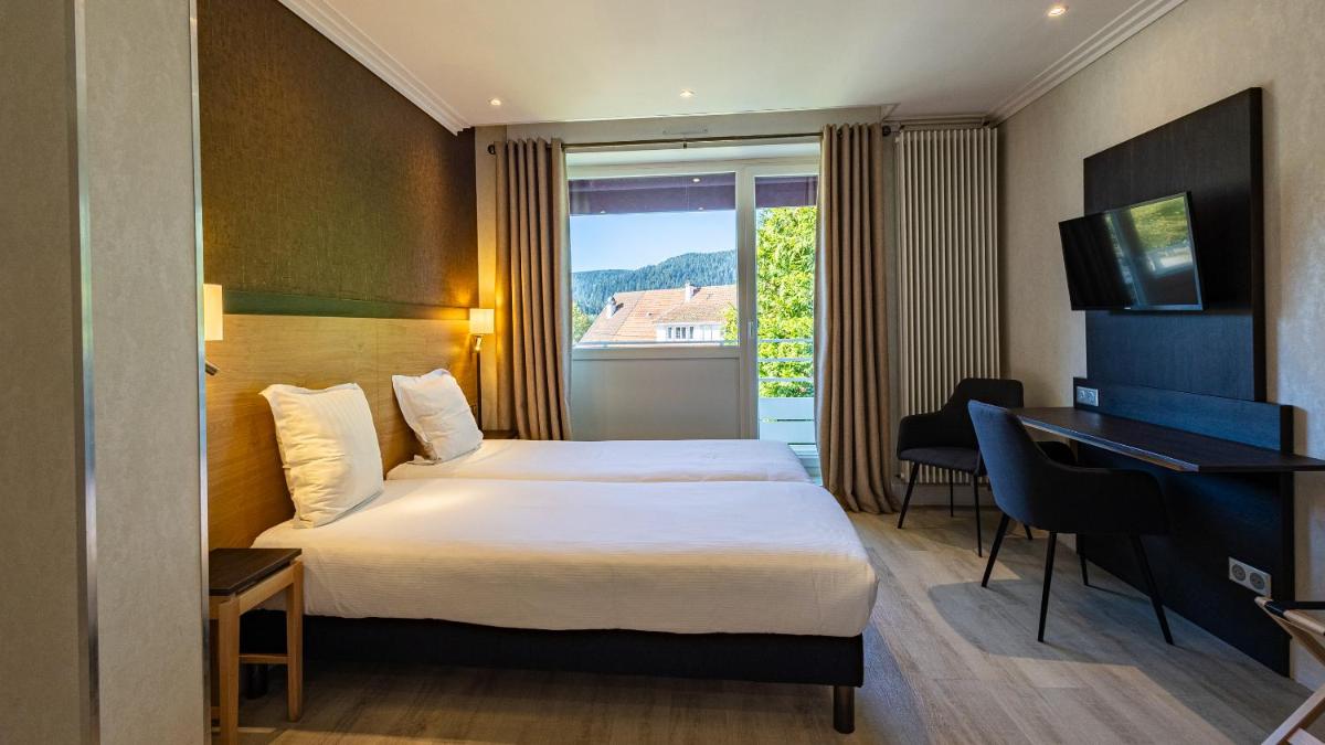 Un ou plusieurs lits dans un hébergement de l'établissement Hôtel Beau Rivage