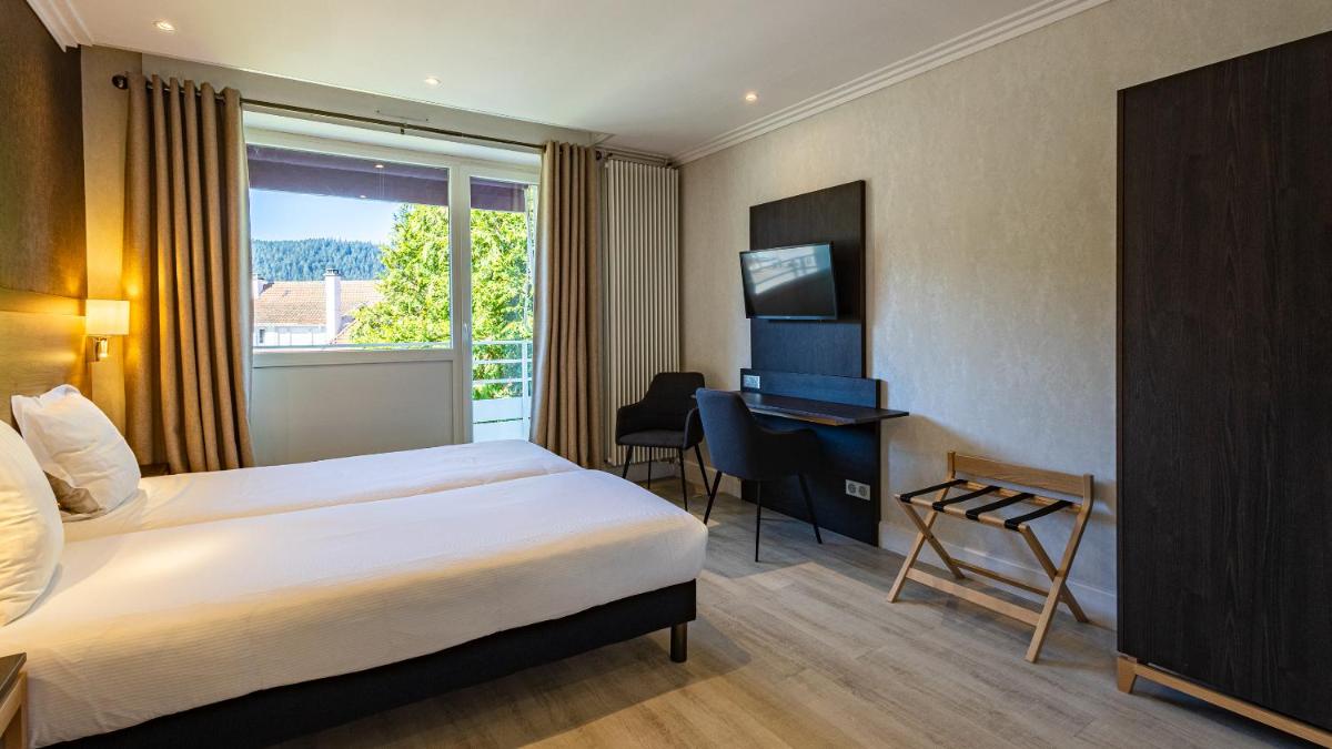 Un ou plusieurs lits dans un hébergement de l'établissement Hôtel Beau Rivage