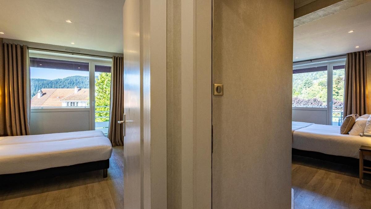 Un ou plusieurs lits dans un hébergement de l'établissement Hôtel Beau Rivage