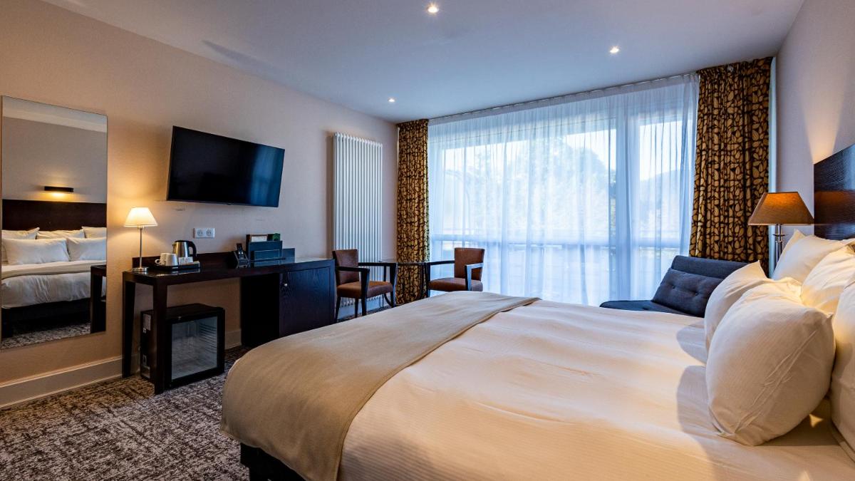 Un ou plusieurs lits dans un hébergement de l'établissement Hôtel Beau Rivage