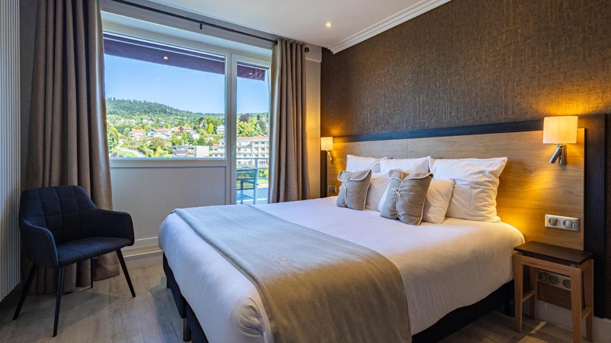 Un ou plusieurs lits dans un hébergement de l'établissement Hôtel Beau Rivage