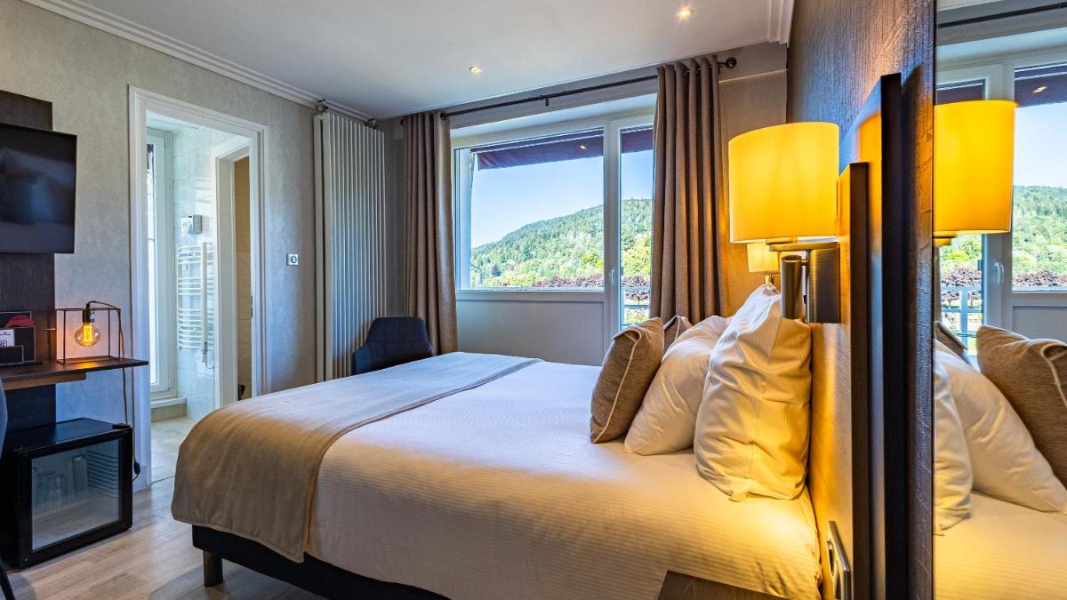 Un ou plusieurs lits dans un hébergement de l'établissement Hôtel Beau Rivage