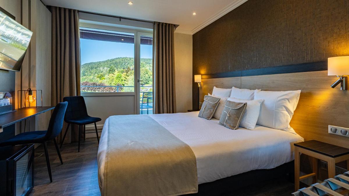 Un ou plusieurs lits dans un hébergement de l'établissement Hôtel Beau Rivage