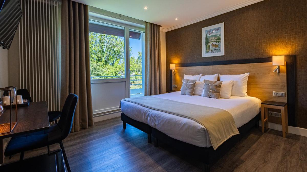 Un ou plusieurs lits dans un hébergement de l'établissement Hôtel Beau Rivage