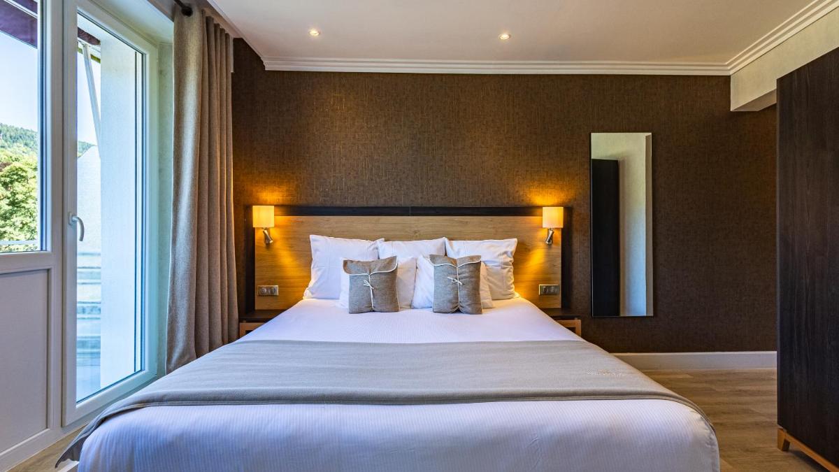 Un ou plusieurs lits dans un hébergement de l'établissement Hôtel Beau Rivage