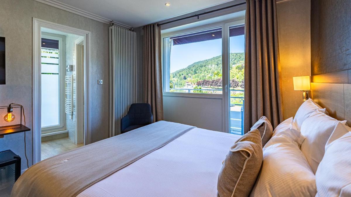 Un ou plusieurs lits dans un hébergement de l'établissement Hôtel Beau Rivage