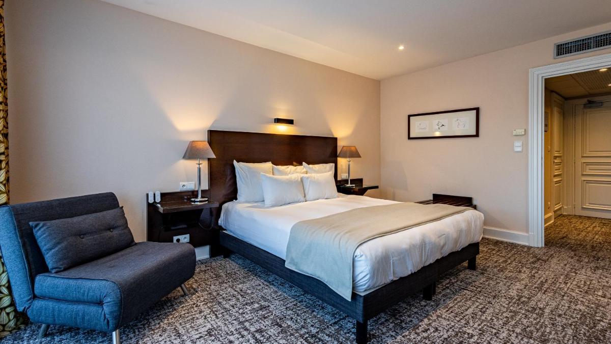 Un ou plusieurs lits dans un hébergement de l'établissement Hôtel Beau Rivage