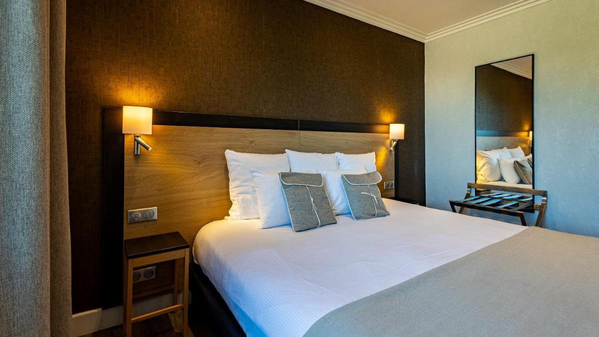 Un ou plusieurs lits dans un hébergement de l'établissement Hôtel Beau Rivage