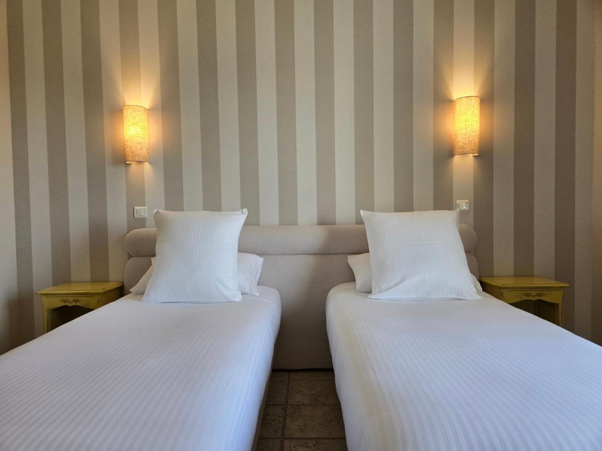 Un ou plusieurs lits dans un hébergement de l'établissement CÉRÈS - Boutique-Hôtel & Spa