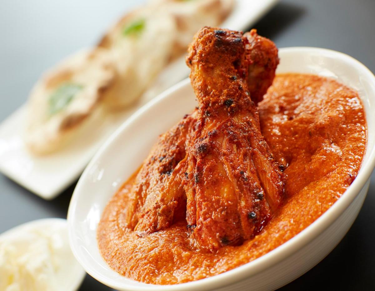 a bowl of sauce with a piece of food in it at Taj Swarna, Amritsar in Amritsar
