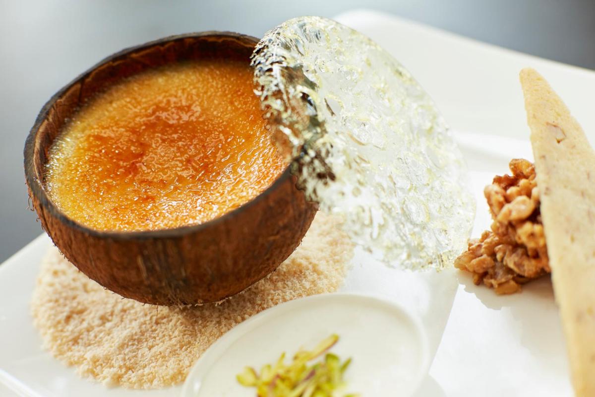 a bowl of food on a white plate with food at Taj Swarna, Amritsar in Amritsar
