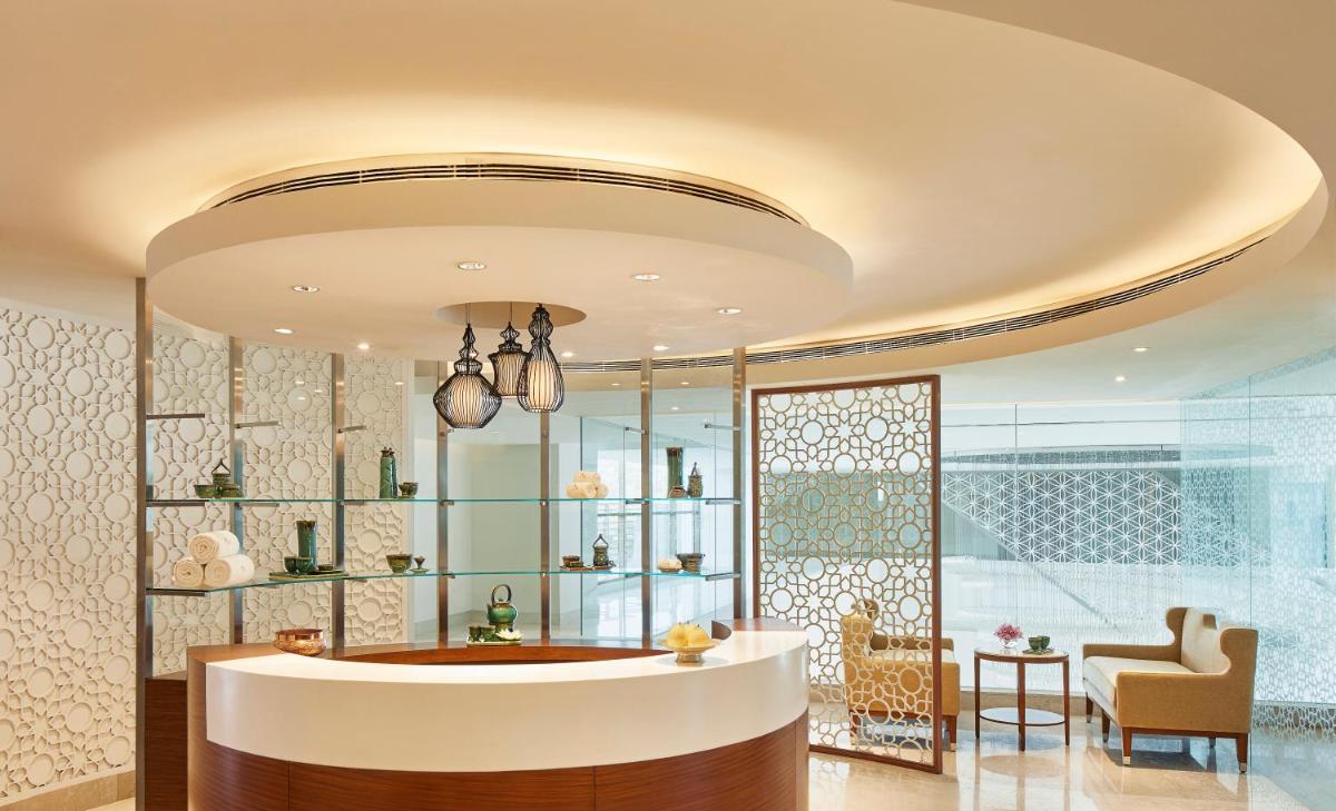 a lobby with a tub and a table and a chair at Taj Swarna, Amritsar in Amritsar