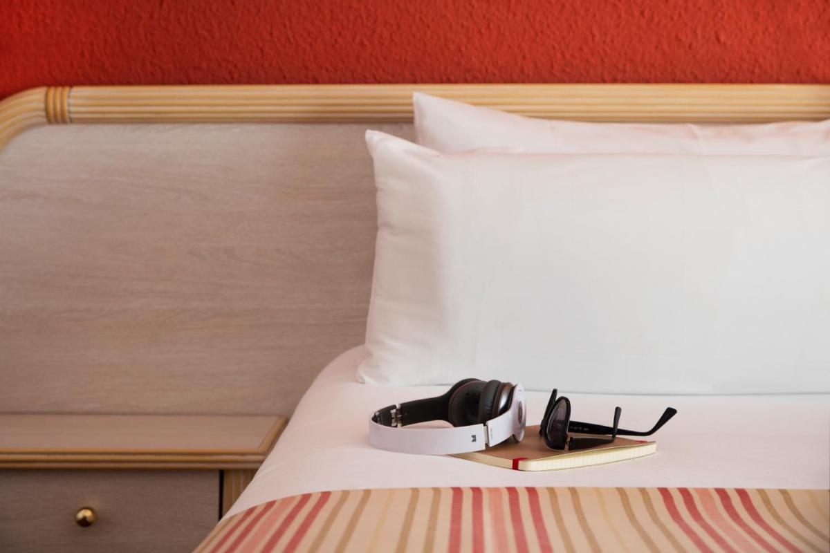 Cama o camas de una habitación en Luna Park Hotel Yoga & Spa