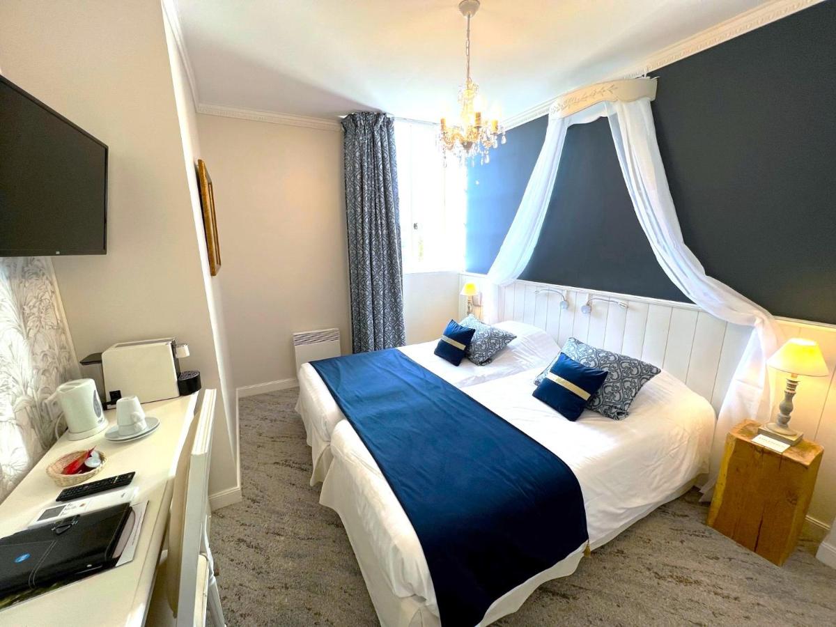 Un ou plusieurs lits dans un hébergement de l'établissement Château Hôtel Edward 1er