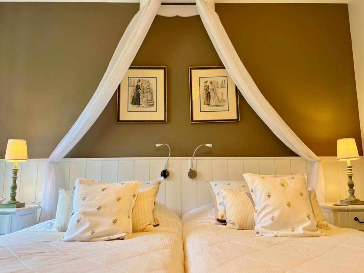 Un ou plusieurs lits dans un hébergement de l'établissement Château Hôtel Edward 1er