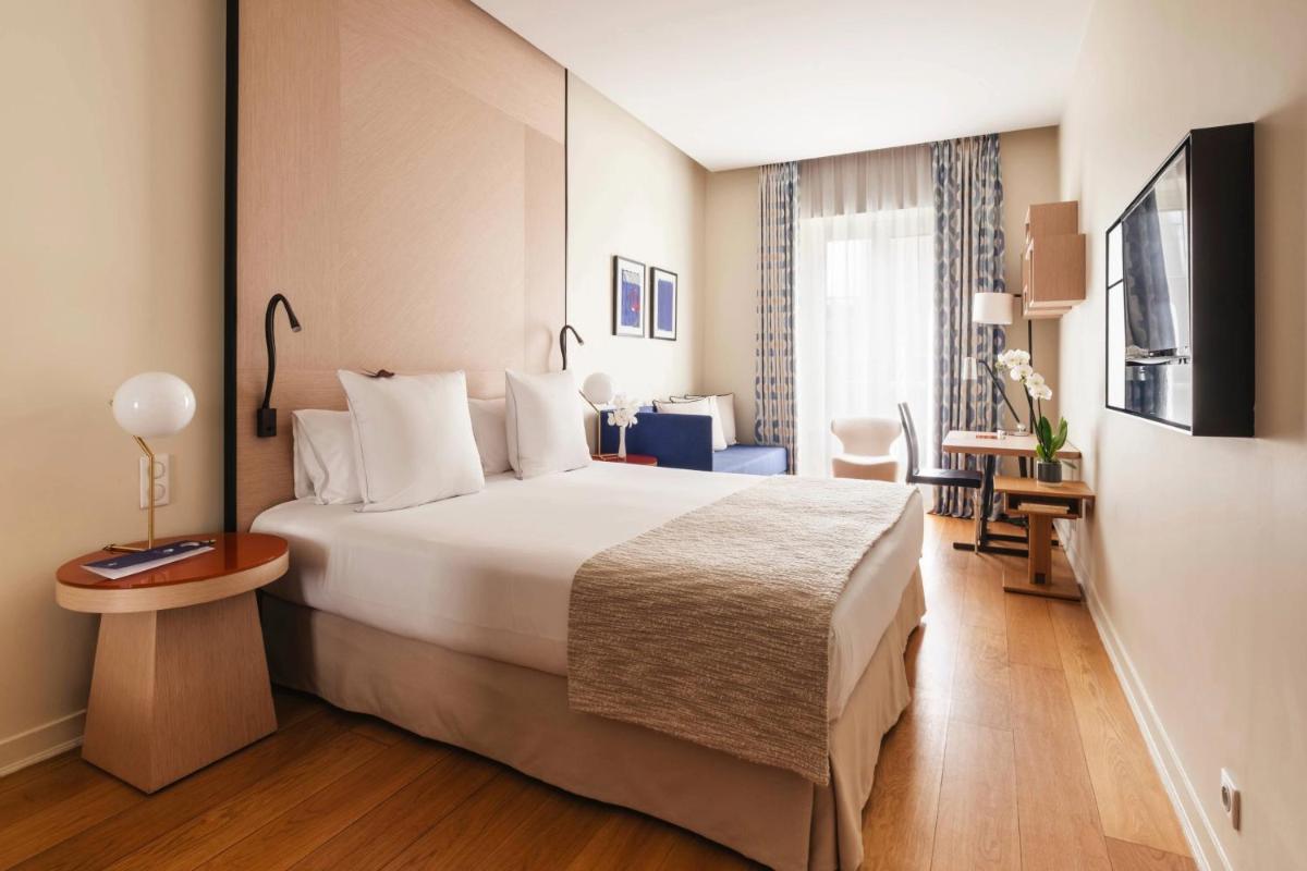 Un ou plusieurs lits dans un hébergement de l'établissement Hôtel Bel Ami