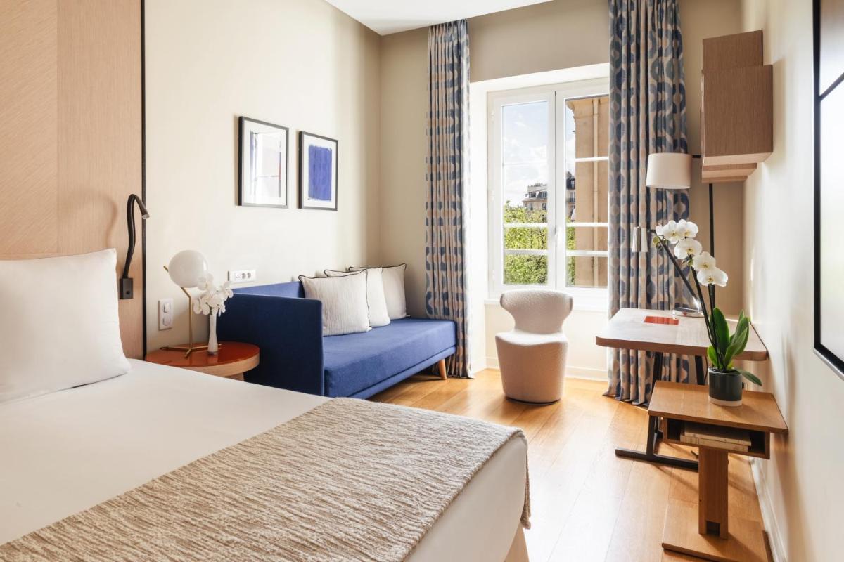 Un ou plusieurs lits dans un hébergement de l'établissement Hôtel Bel Ami