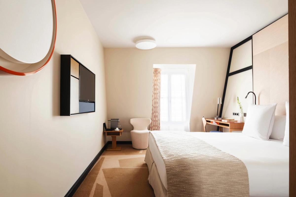 Un ou plusieurs lits dans un hébergement de l'établissement Hôtel Bel Ami